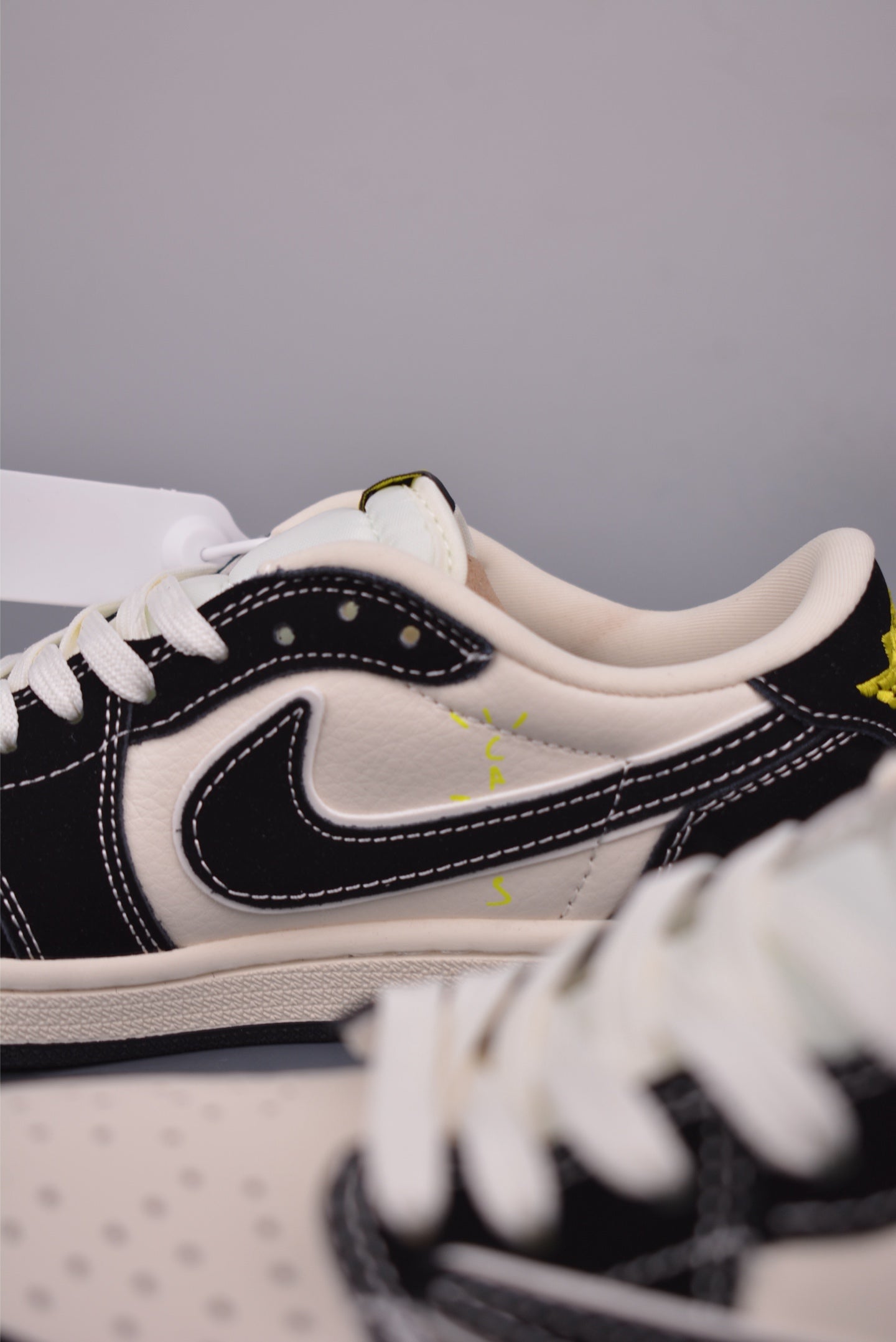 Detalles de las Air Jordan 1, con enfoque en el lema y diseños únicos de Travis Scott.